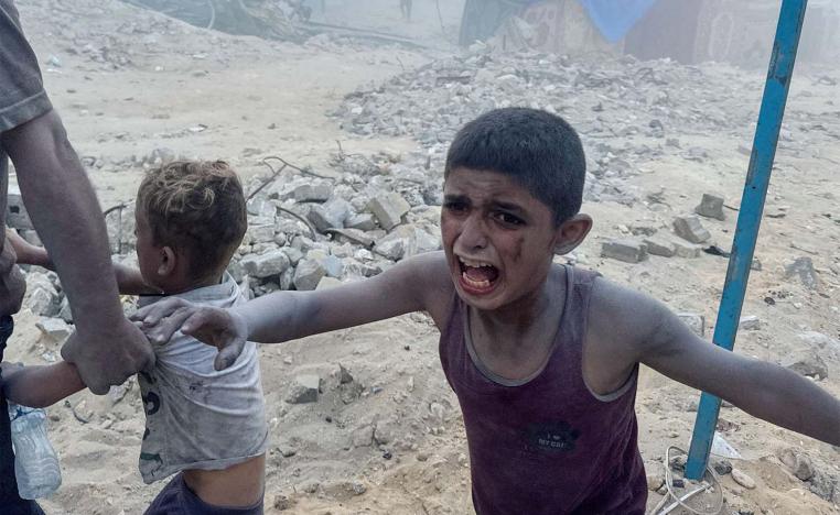A Palestinian child cries following an Israeli strike near a UN-run school sheltering displaced people in Khan Younis