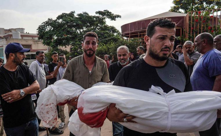 Mourners carry the bodies of members of the Qadih family to a burial ground in Khuzaa in the southern Gaza Strip