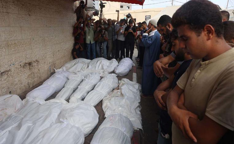 Palestinians mourn their relatives, killed in an Israeli strike on Central Gaza