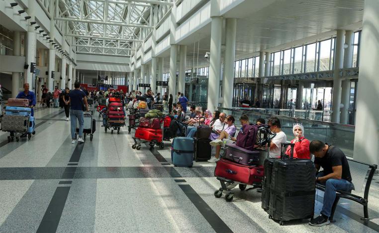 People wait with their luggage at Beirut-Rafiq Hariri International Airport