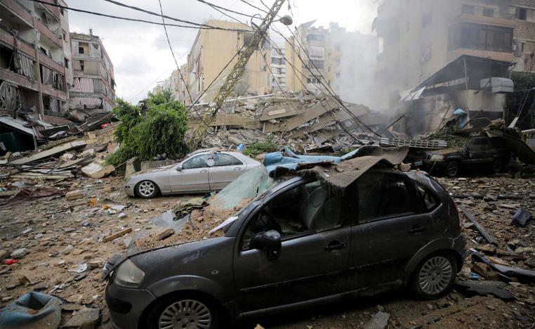 Damaged vehicles and buildings, in the aftermath of Israeli strikes on Beirut's southern suburbs