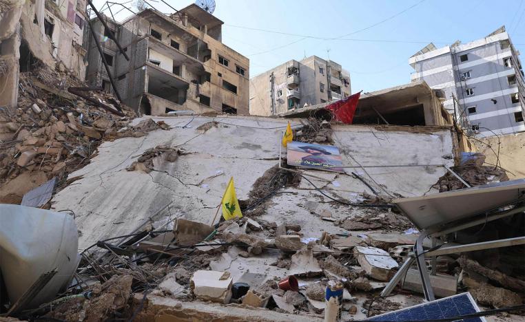 Yellow flags of Hezbollah are stuck on a building destroyed in recent Israeli bombardment in southern Beirut's Ruweiss district 