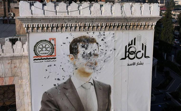 جدارية مشوهة للرئيس بشار الأسد وسط حماة