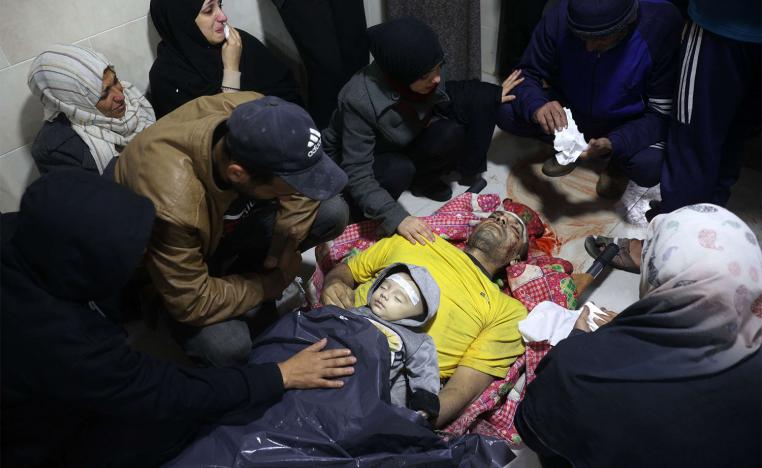 Palestinians mourn relatives killed in an Israeli airstrike in the Nuseirat refugee camp