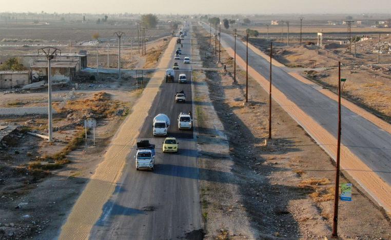 Syrian Kurds driving vehicles loaded with belongings on the Aleppo-Raqqa highway 