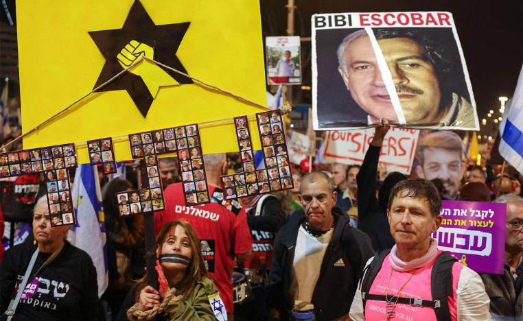  Protesters hold placards and wave flags during a demonstration calling for the release of hostages held captive in Gaza 