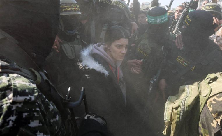 Palestinian militants surround hostage Arbel Yehoud during her handover to the ICRC