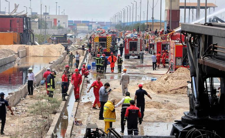 Iranian Red Crescent rescuers work following an explosion at the Shahid Rajaee port in Bandar Abbas