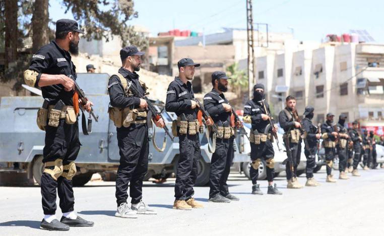 yria's security forces standing guard in a street in the mostly Druze and Christian Jaramana suburb of Damascus