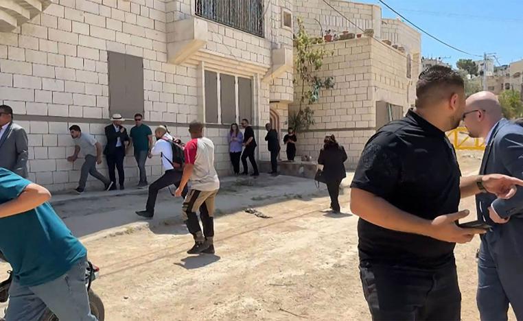 Members of a diplomatic delegation from the European Union reacting after shots were fired as they gathered in Jenin camp