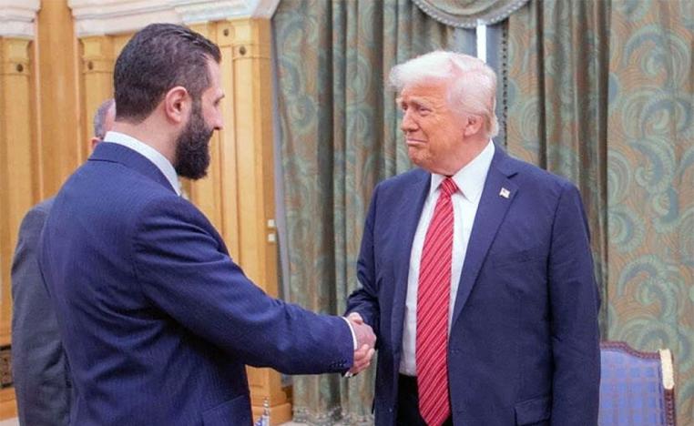Trump shaking hands with Sharaa