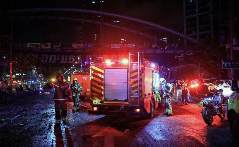 First responders work at an impact site following missile attack from Iran on Israel, in Tel Aviv