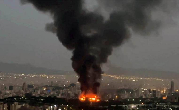 Smoke rises from a fire in Tehran as the Israel-Iran air war continues