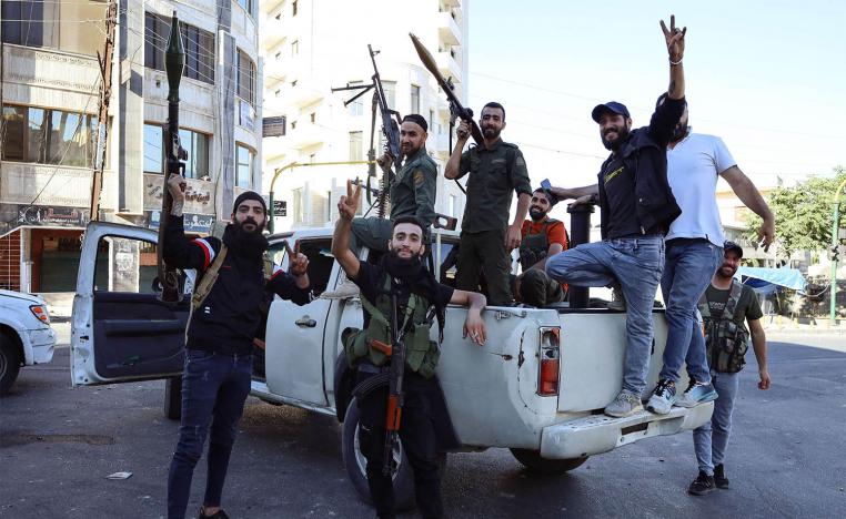Syrian Druze fighters pose for a photograph after Syrian government forces pulled out of the Sweida governorate