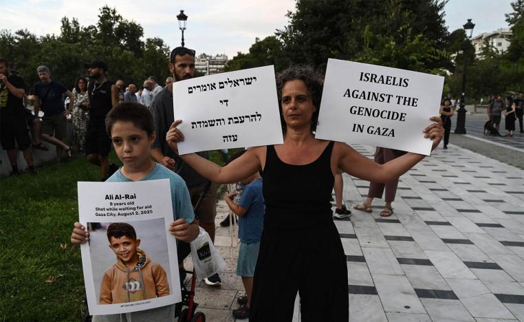 An Israeli citizen holds placard as she take part in a pro-Palestinian rally against Israels actions and ongoing food shortages in the Gaza Strip, during a protest in Thessaloniki 