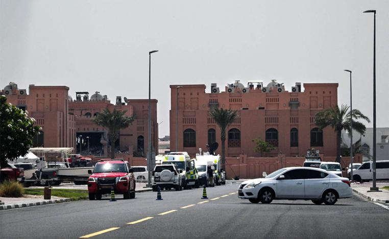 the damaged building (L) in The compound housing members of Hamas political bureau which was targeted the previous day by an Israeli strike in Doha