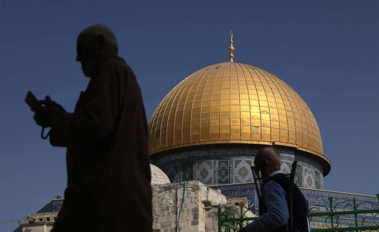 Muslim worshippers walk next to the Dome of the Rock mosque at the Al-Aqsa mosque compound in Jerusalems Old City 