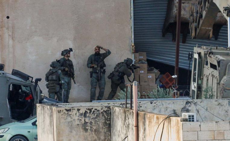 Israeli soldiers take position during a raid in Jenin in the Israeli-occupied West Bank