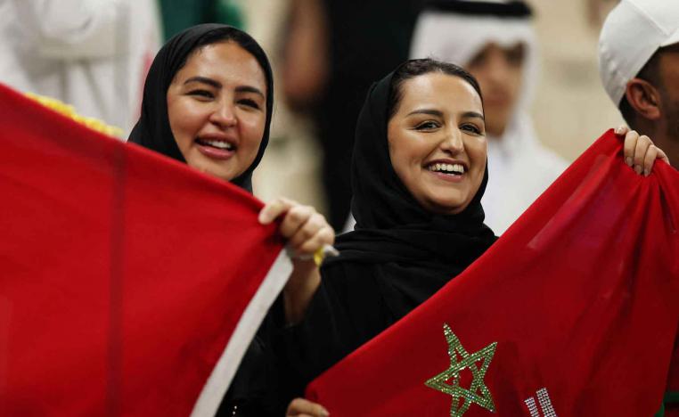 Morocco fans raise the national flag at the Lusail Stadium in Qatar.