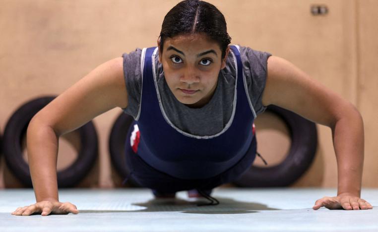Wrestler Rodaina Gamal, 15, in action during a training session at the one-room Manshiya club in El Mansoura, Egypt, December 15, 2025. 