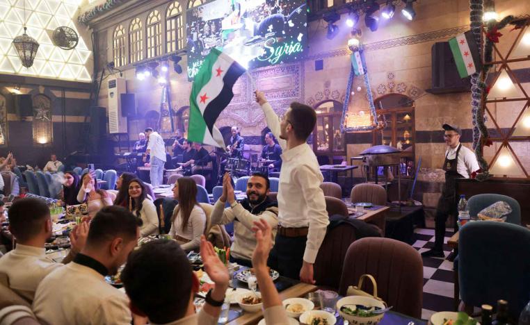 People gather on Christmas day at a restaurant in Damascus.