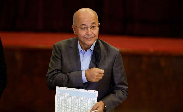 Iraq’s former president Barham Salih casts his vote at a polling station in Baghdad, as Iraqis go to the polls to vote in the parliamentary election, October 10, 2021. 