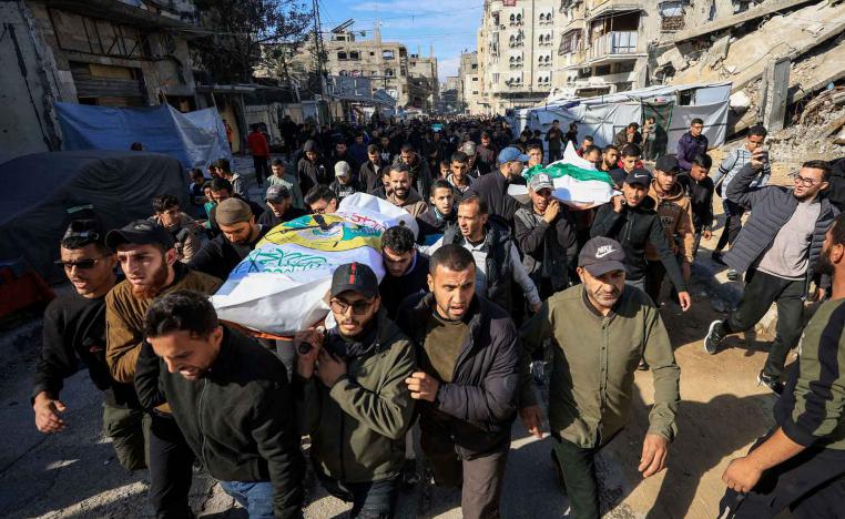 Mourners carry bodies during the funeral of Hamas senior commander Raed Saed and his aides, in Gaza City, December 14, 2025. 