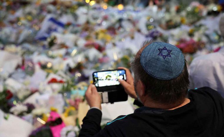 A man wearing a kippah with a Star of David on it pays his respects at Bondi Pavilion to victims of a shooting during a Jewish holiday celebration at Bondi Beach, in Sydney, December 15, 2025. 