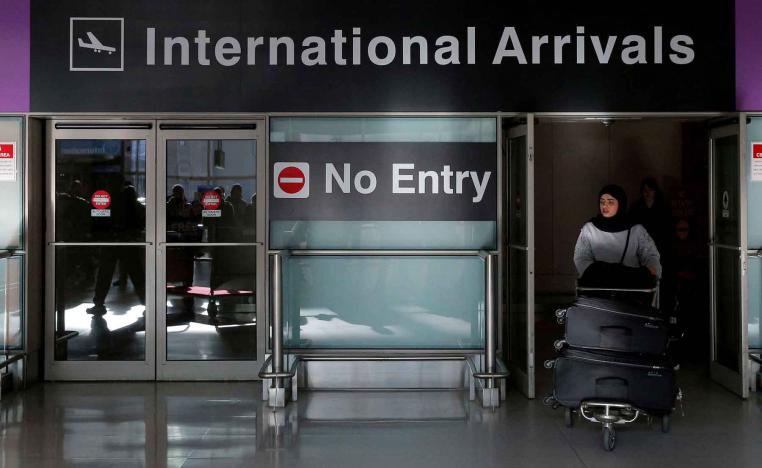  An international traveller arrives at Logan Airport in Boston, Massachusetts, US.