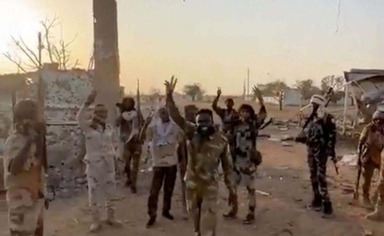 Members of Sudans paramilitary Rapid Support Forces (RSF) stand in front of the main gate of the 22nd SAF Infantry Division, in Babanusa