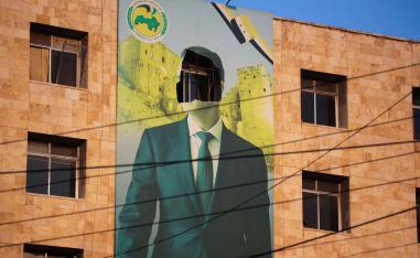 A damaged poster of Syria’s former president Bashar al-Assad in Aleppo, November 30, 2024. 