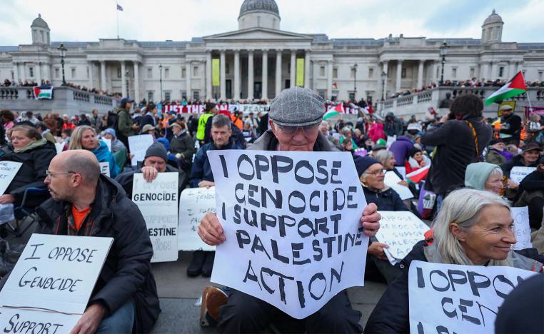 Protesters hold placards during a mass demonstration in London against the British governments ban on Palestine Action last October