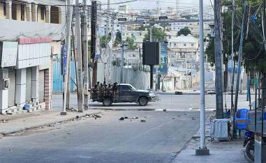 A truck carrying Somali security forces drives across a street ahead of a protest against Somalia's President