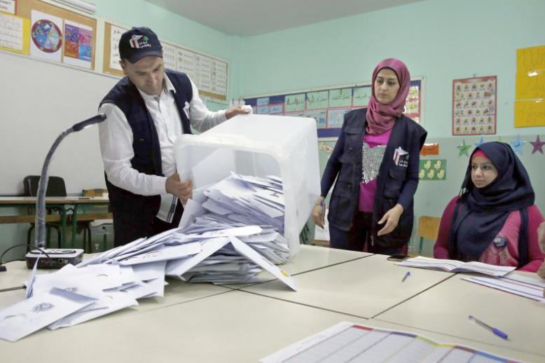 Election officials prepare to count ballots shortly after the polling stations closed in Beirut, on May 6