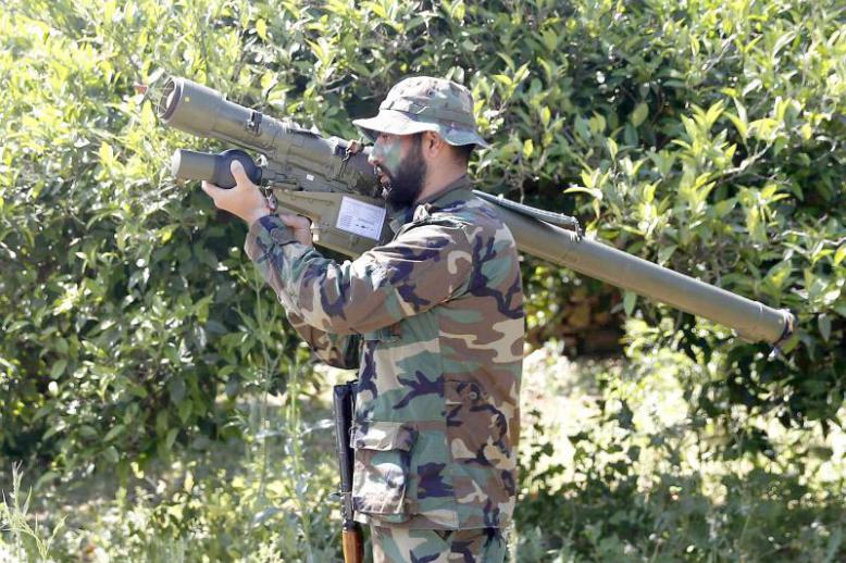 A Hezbollah fighter holds an Iran-made anti-aircraft missile launcher on the border with Israel in Naqoura