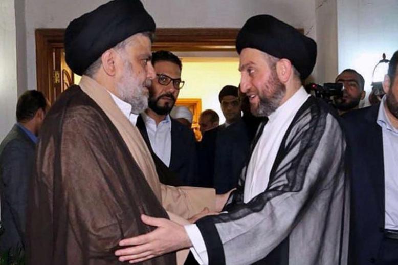 Shia cleric Muqtada al-Sadr (L) greets Shia leader Ammar al-Hakim in Baghdad, on May 22