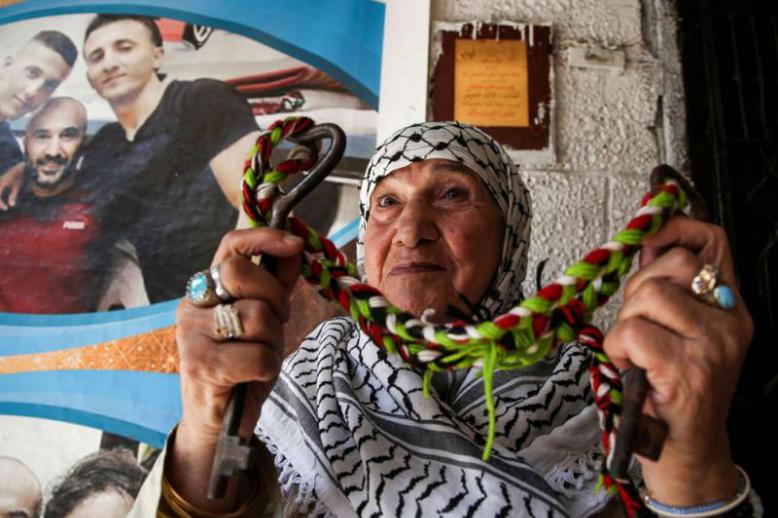 A Palestinian woman holds the key of her family’s home as she sits at the Balatah refugee camp in the occupied West Bank, on September 2.