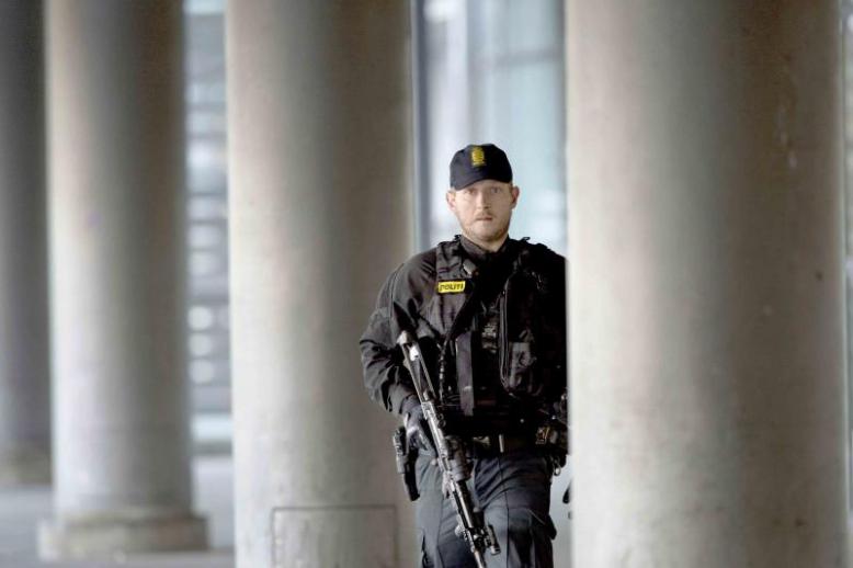 A Danish policeman stands guard outside a building in Copenhagen