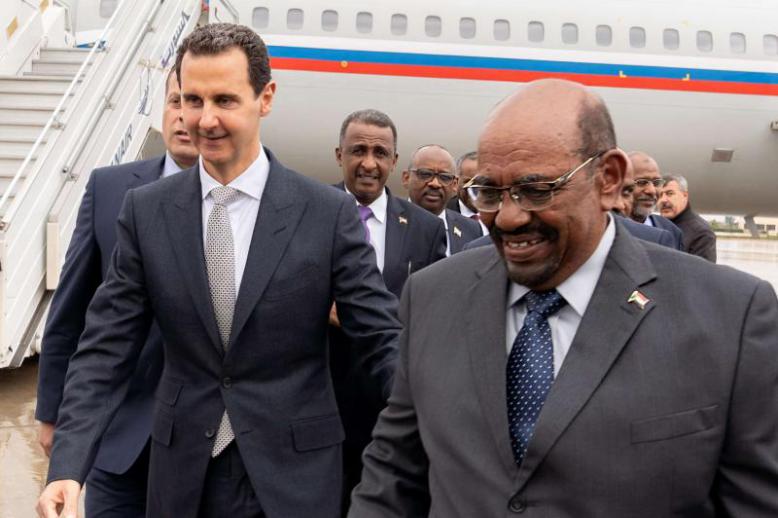 Breaking isolation? Syrian President Bashar Assad (L) receiving Sudanese President Omar al-Bashir at Damascus Airport, December 16