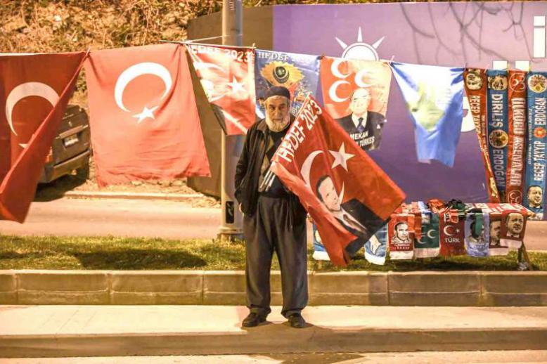 An AKP supporter stands near the headquarters of the party in Istanbul, March 31