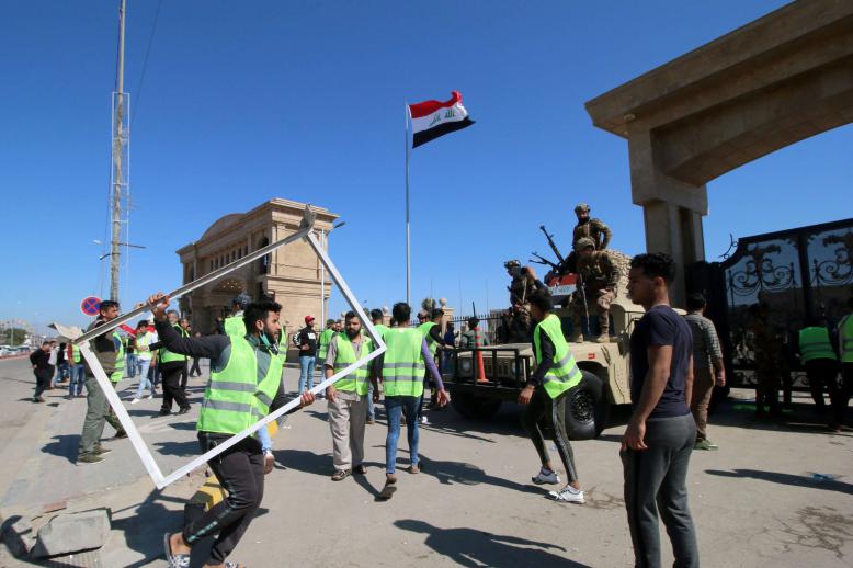 Iraqis protest near the provincial council building in Basra, last March