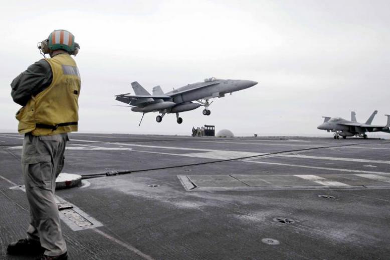  A US fighter jet lands on the USS Abraham Lincoln aircraft carrier during exercises in the Arabian Gulf