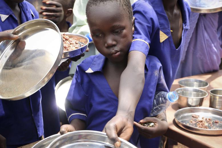 أطفال سودانيون يحصلون على حبوب مطبوخة خلال مبادرة للتغذية أطلقتها اليونيسف