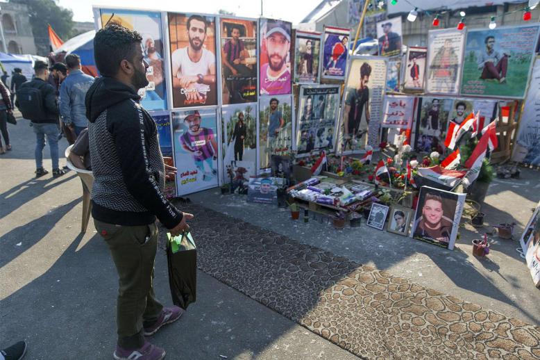 Symbolic graves adorned with names and pictures of anti-government protesters, who have been killed in protests at Baghdad's Tahrir Square