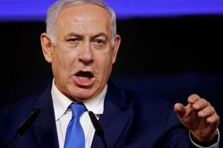 Israeli Prime Minister Benjamin Netanyahu addresses supporters at his Likud Party headquarters in Tel Aviv