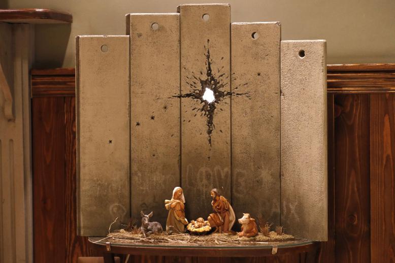 A new Christmas-themed artwork dubbed the "Scar of Bethlehem" by secretive British artist Banksy is displayed at his Walled-Off Hotel in Bethlehem