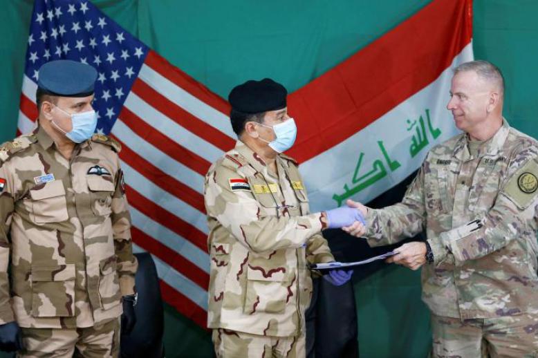 17 years on: US and Iraqi generals shake hands during the handover of Qayyarah Airfield West from US-led coalition forces to the Iraqi military