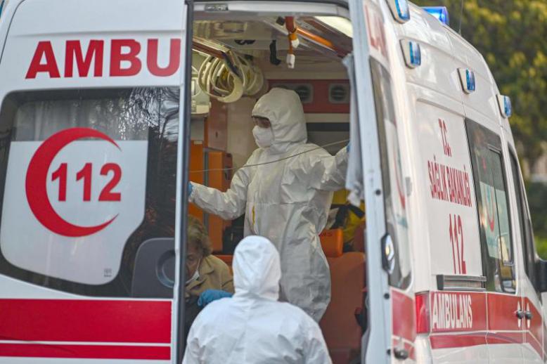 First aid workers look after a woman suspected of being infected with COVID-19