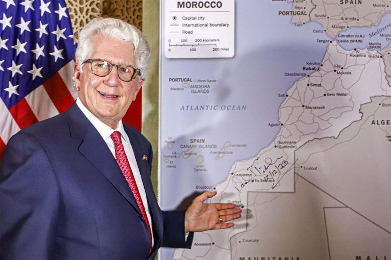 David T. Fischer, US Ambassador to Morocco, stands before a US State Department-authorised map of Morocco recognising the Western Sahara as a part of the North African kingdom