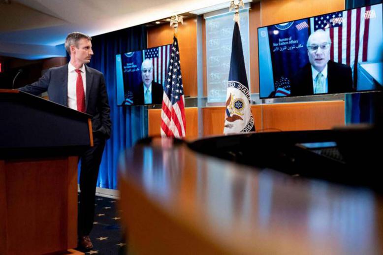 State Department spokesman Ned Price (L) listens as US special envoy for Yemen Timothy Lenderking speaks via teleconference during a news conference at the State Department in Washington